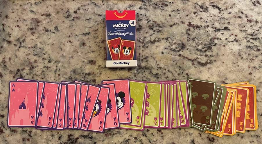 Walt Disney's Mickey and Friends playing cards spread out on a table