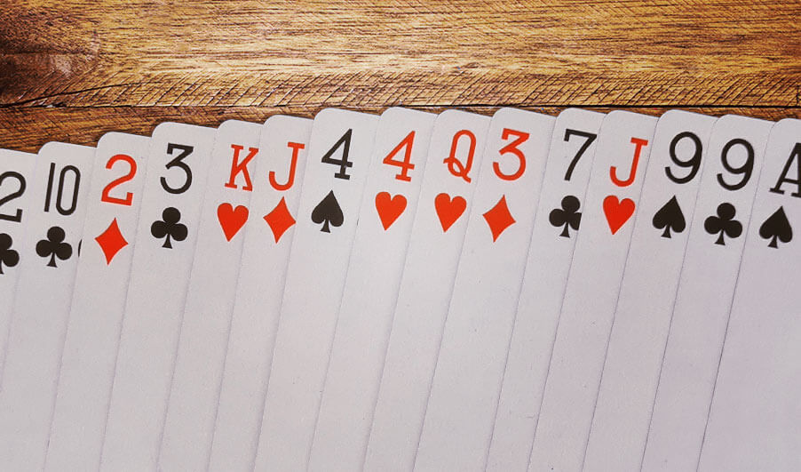Spread out playing cards on a wooden table